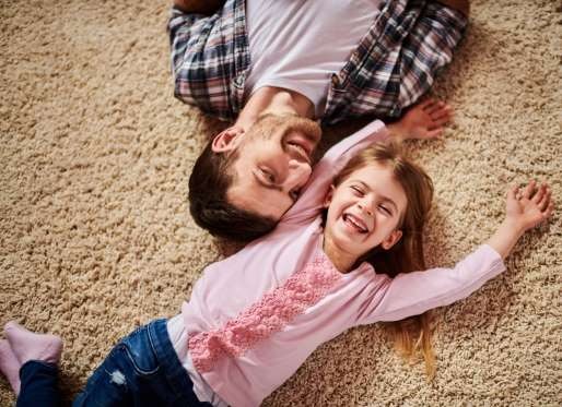 father, daughter on carpet